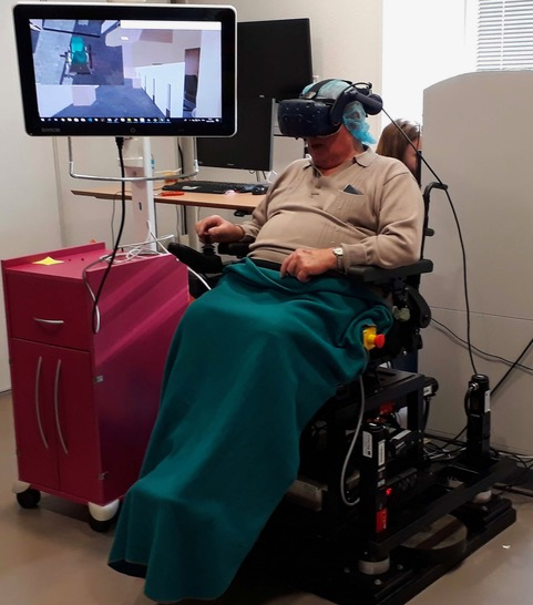 Virtual Reality condition setup of our clinical study with our power wheelchair simulator.
