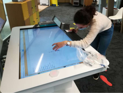 A user is moving a token on a multi-touch tabletop.